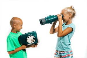 A girl and boy posing and pointing different playset attachments at each other.