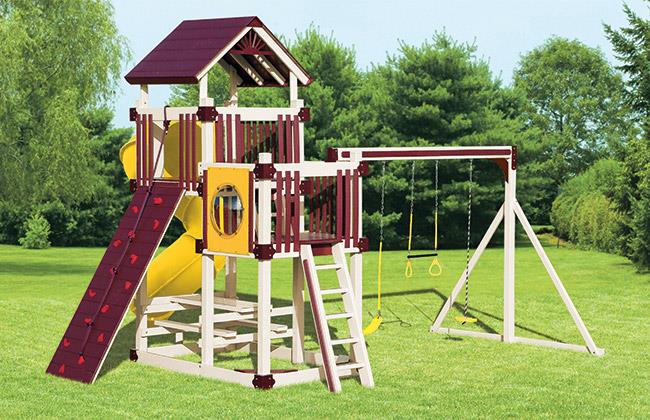 yellow and burgandy playset with slide and rock wall