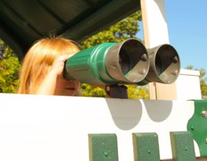 little girl using playset binoculars for look-out
