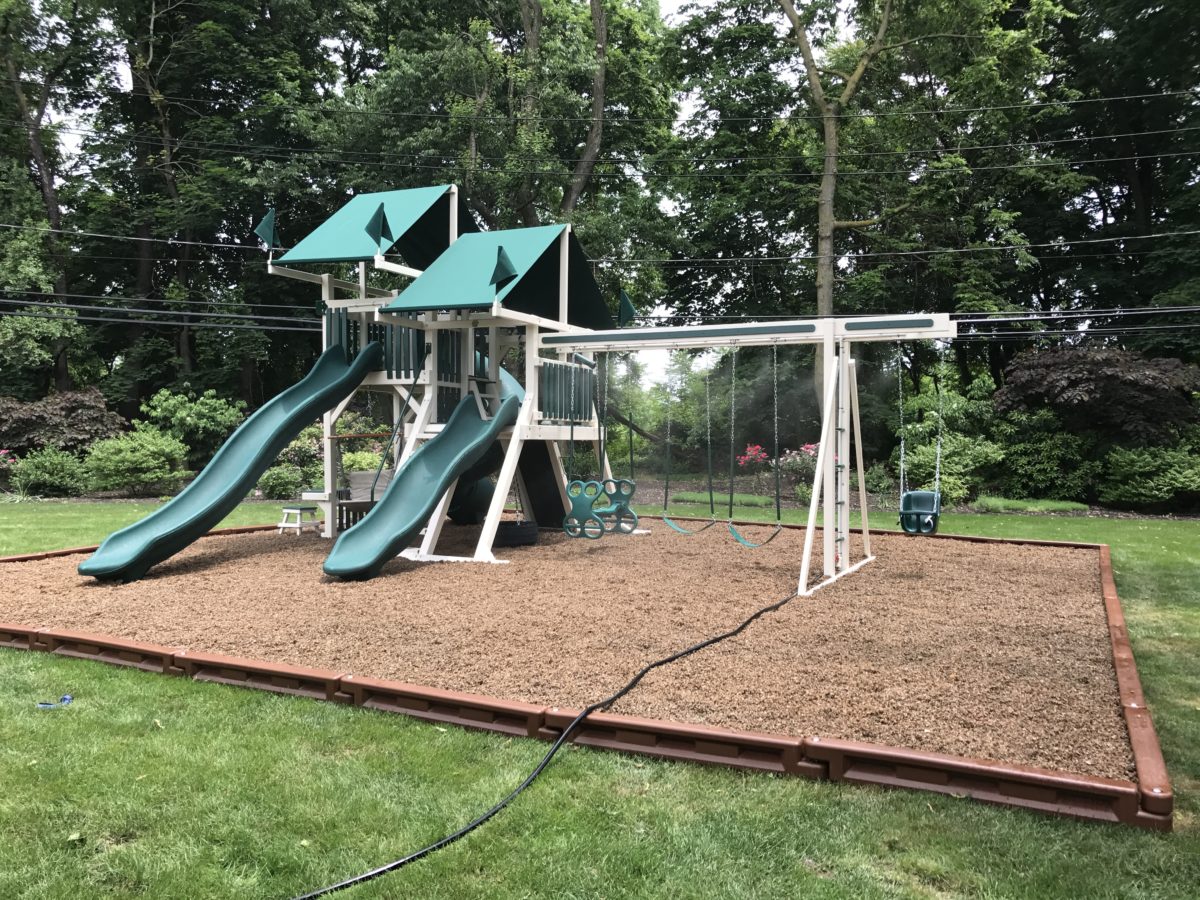 green and white playset with a double tower and double slides scaled
