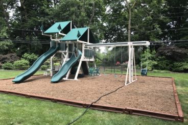 green and white playset with a double tower and double slides scaled