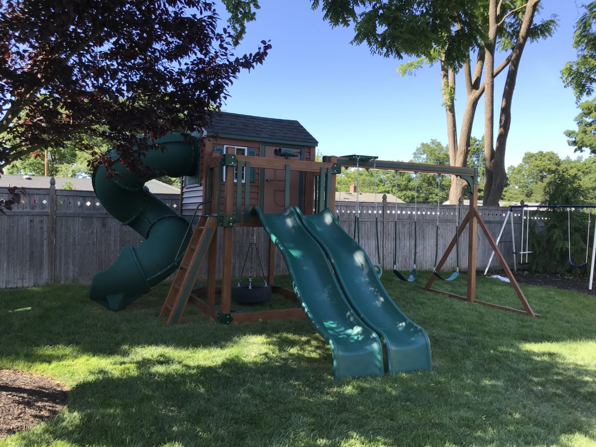 wood and green playset with double slides
