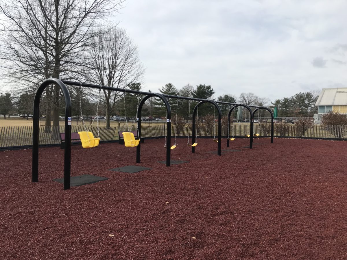 yellow and black swing set at a park