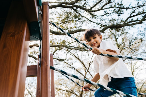 a boy playing on a playset