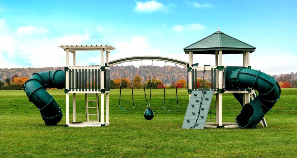 a swing kingdom playset with an arched monkey bar, pergola roof, rock wall, and more