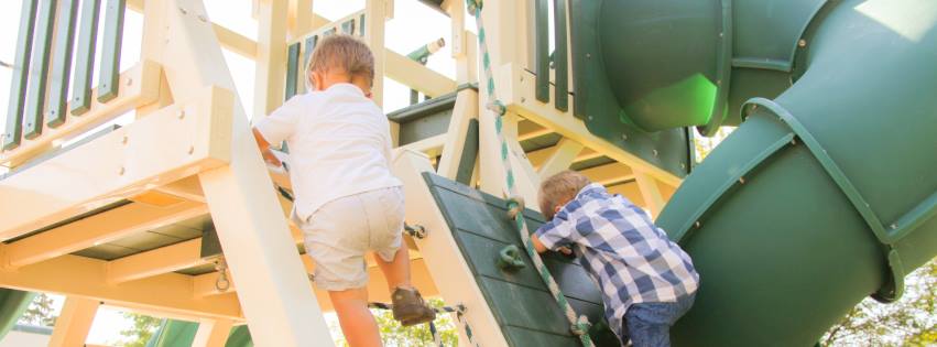 two boys climbing on customized playset